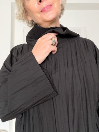 Blusa asimmetrica in tessuto goffrato con collo alto