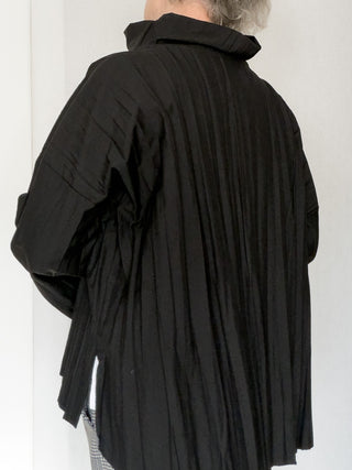 Blusa asimmetrica in tessuto goffrato con collo alto